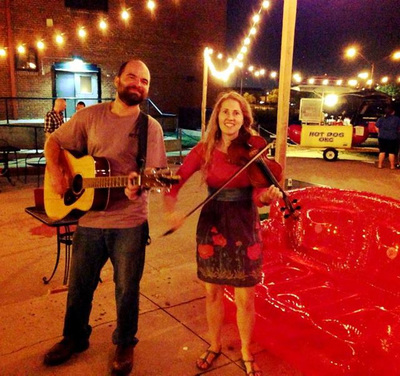 Casey Friedman and Minna Biggs play fiddle and guitar at the Wedge pizza restaurant in the Deep Deuce district in Oklahoma City.